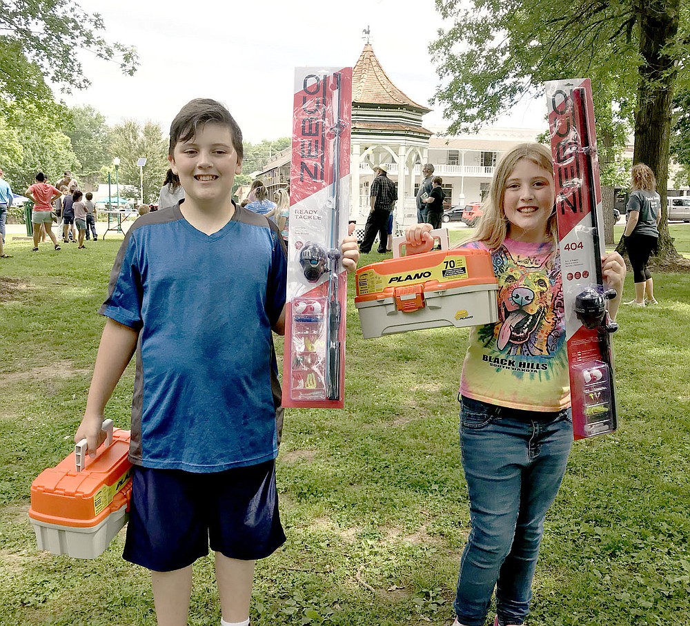 Photo Submitted Pictured are brother and sister Stephen Baker (left), and Esther Baker who each won their age and gender categories for largest fish at the derby. These are some of the prizes they won.