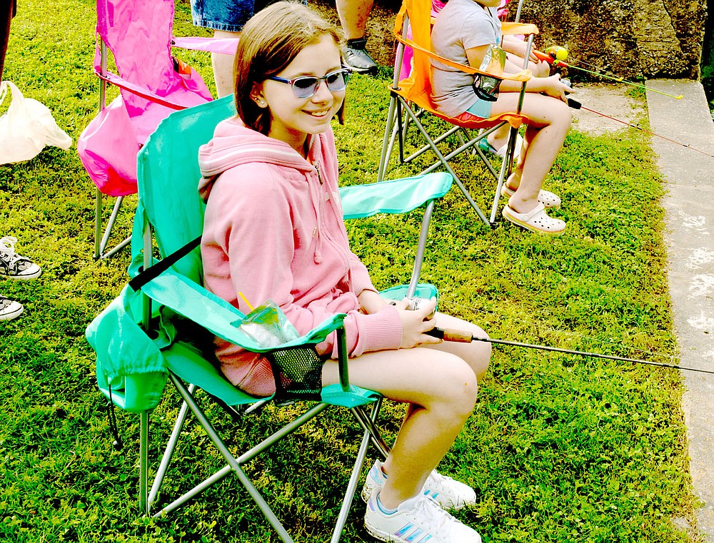 Marc Hayot/Herald-Leader Farrah Vaughan, 10, sits back and enjoys the morning as she fishes in the fishing derby held by the Parks and Recreation Department.