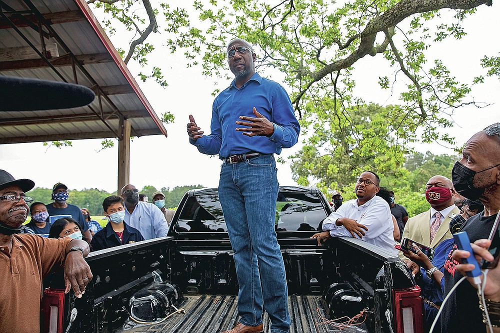 U.S. Sen. Rev. Raphael Warnock speaks with Black farmers in Byromville, Ga., on Tuesday, May 4, 2021. Warnock addressed targeted federal relief in the American Rescue Plan for farmers of color and vowed to tackle the history of discriminatory practices by the United States Department of Agriculture. (Riley Bunch/The Daily Times via AP)