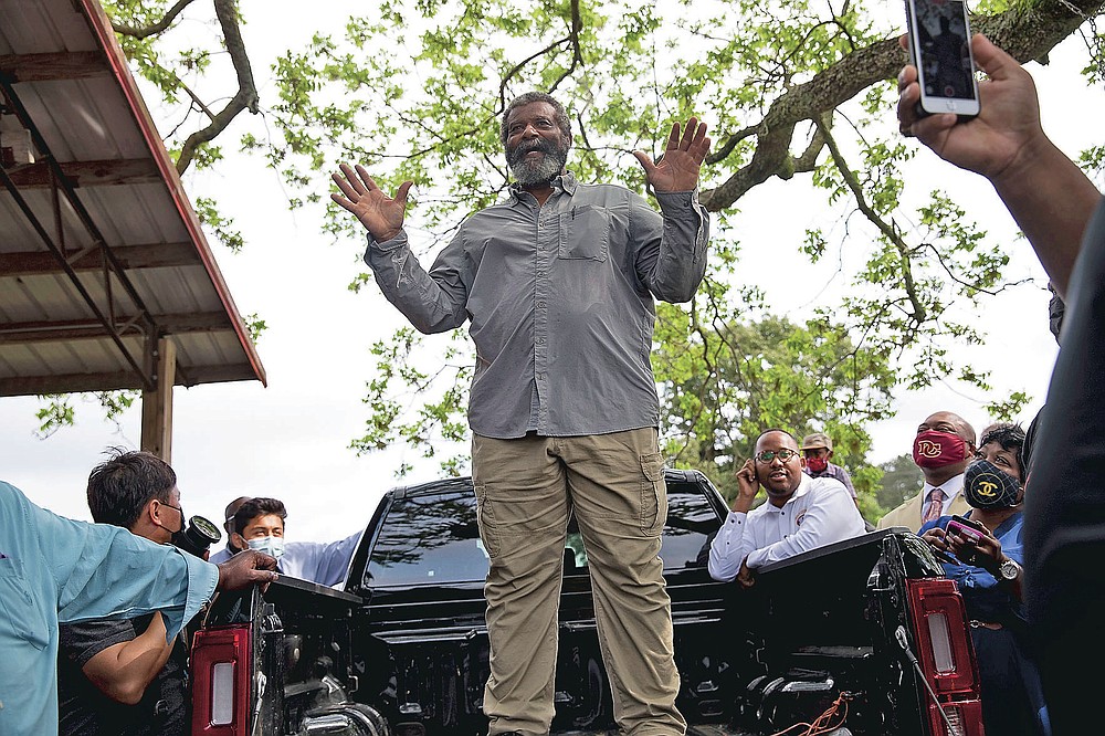 Howard James, owner of Jibbs Vineyard in Byromville, Ga., introduces U.S. Sen. Rev. Raphael Warnock to the crowd of Black farmers gathered at his farm on Tuesday, May 4, 2021. (Riley Bunch/The Daily Times via AP)