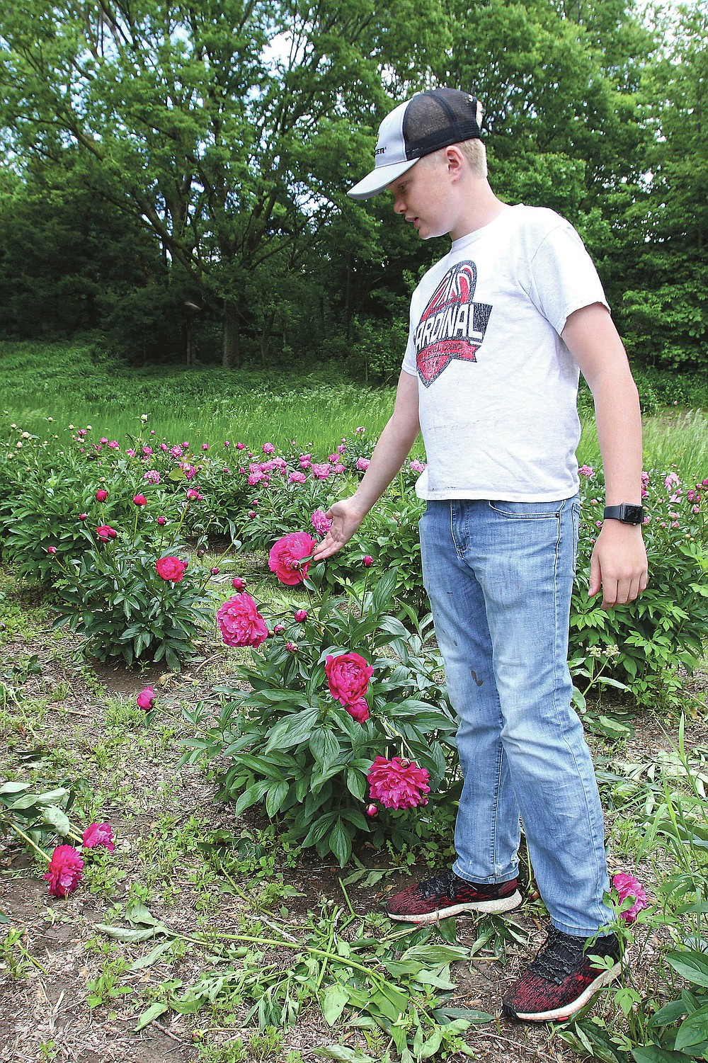 Preston Sjuts talks about some of his favorite varieties of peonies Thursday, May 27, 2021, during a tour of Sjuts Peony Garden south of Trumbull, Neb. (Laura Beahm/The Hastings Tribune via AP)
