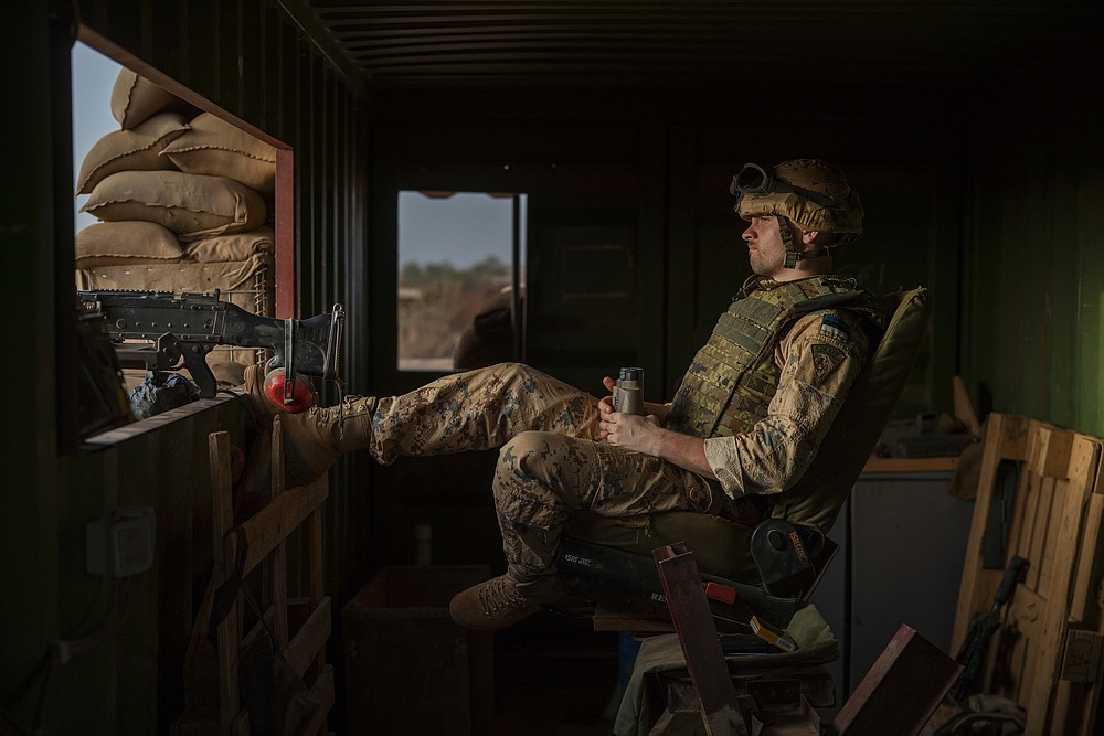An Estonian Barkhane force soldier mans the checkpoint at the entrance of their base in Gao, eastern Mali, Sunday June 6, 2021. Col. Assimi Goita who retook control of Mali's transitional government May 24 2021 by forcing the resignations of the civilian transitional president and prime minister is to be inaugurated in the capital Bamako Monday June 7, 2021. Meanwhile, France has suspended joint military operations with Malian forces until the junta complies with international demands to restore civilian rule. (AP Photo/Jerome Delay)