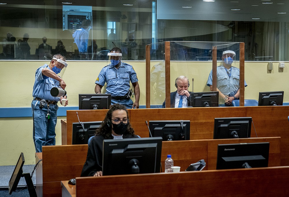 Former Bosnian Serb military chief Ratko Mladic sits in the court room in The Hague, Netherlands, Tuesday, June 8, 2021, where the United Nations court delivers its verdict in the appeal of Mladic against his convictions for genocide and other crimes and his life sentence for masterminding atrocities throughout the Bosnian war. (Jerry Lampen/Pool via AP)