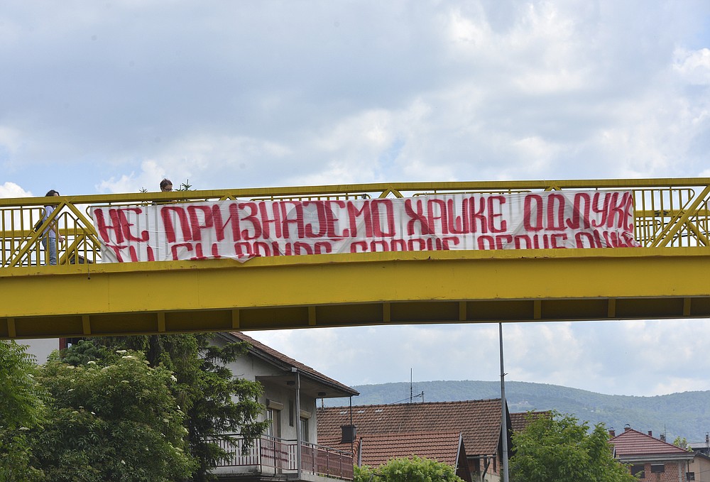 A banner reading "We don't recognize decisions of the Hague" in Serbian Cyrillic letters hangs off a pedestrian overpass on a street in Banja Luka, Bosnia and Herzegovina, Tuesday, June 8, 2021. UN appeals judges on Tuesday, June 8, 2021 upheld the conviction of former Bosnian Serb military chief Ratko Mladic for genocide and other offenses during Bosnia's 1992-95 war and confirmed his life sentence. (AP Photo/Radivoje Pavicic)