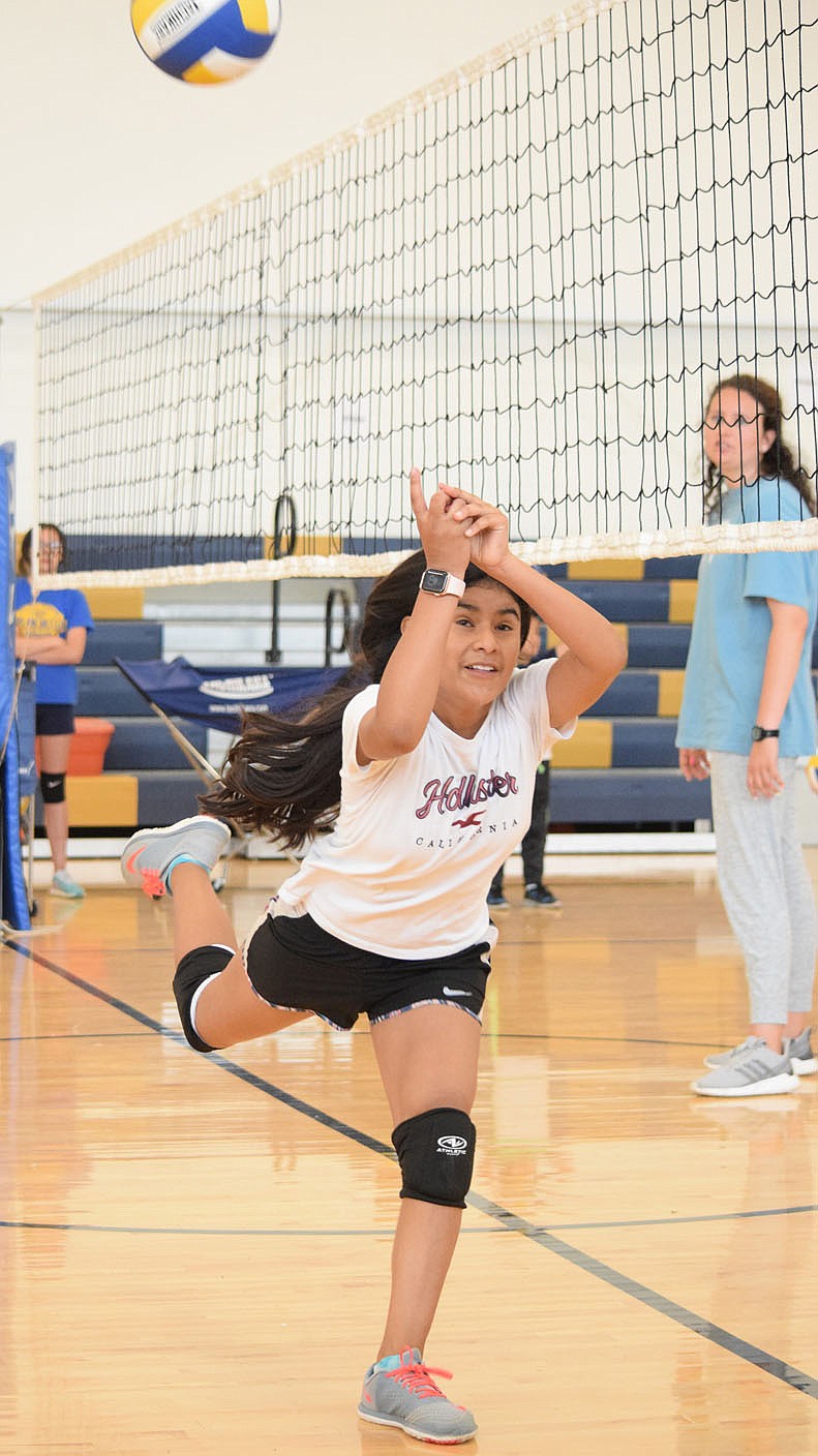 Westside Eagle Observer/MIKE ECKELS
Leslie Hernandez manages to catch a ball hit just inside her side of the court during the Lady Bulldog volleyball practice in the gym at Decatur Middle School June 9. Hernandez managed to send the ball to one of her teammates on the other side of the court who sent it back over the net.