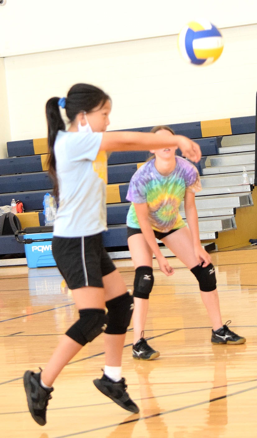 Westside Eagle Observer/MIKE ECKELS
Anna Xiong uses a forearm pass to send the ball back over the net during the June 9 Lady Bulldog junior high volleyball practice in the gym at Decatur Middle School.