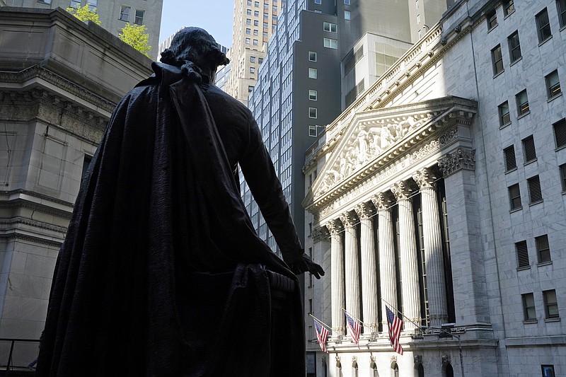 The Federal Hall statue of George Washington overlooks the New York Stock Exchange, Monday, June 7, 2021. Stocks are off to a mixed start on Wall Street as technology companies climb while banks and energy companies fall. The S&P 500 index edged up 0.1% in the early going Tuesday, June 8 while the Dow Jones Industrial Average was slightly lower. (AP Photo/Richard Drew)