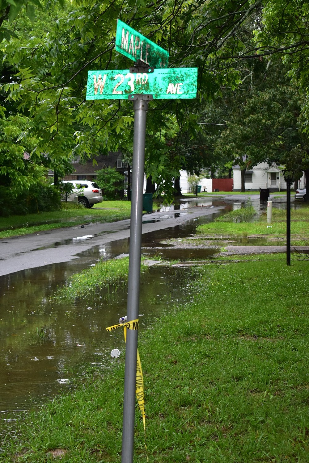 A piece of crime scene tape remains on a street pole at the intersection of West 23rd Avenue and South Maple Street on Tuesday. A 14-year-old girl was found dead in a small SUV following a shooting at this intersection. (Pine Bluff Commercial/I.C. Murrell)