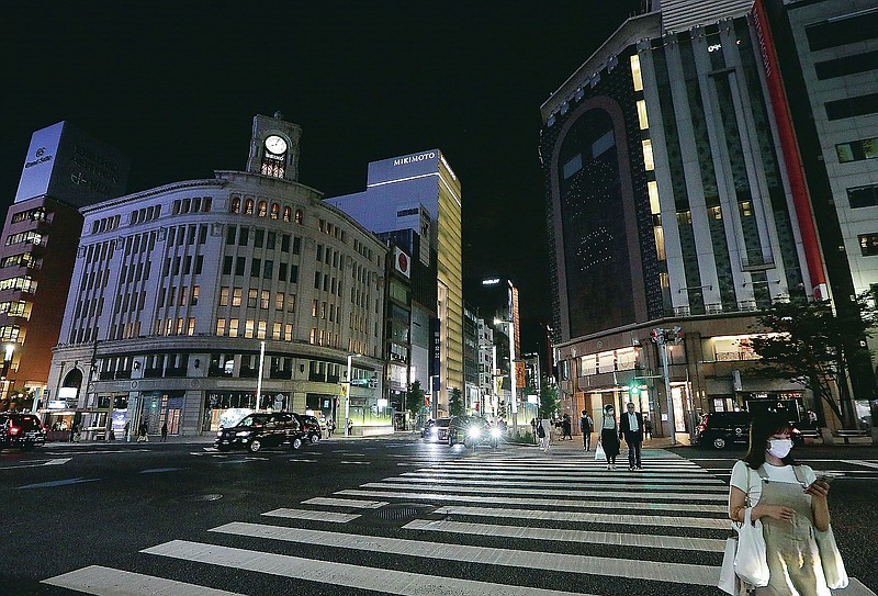 Quiet Ginza shopping district is seen after the 8 p.m. government suggested closing time for restaurants, bars and non-essential businesses under the extended state of emergency in Tokyo, Tuesday, June 1, 2021. (AP Photo/Koji Sasahara)