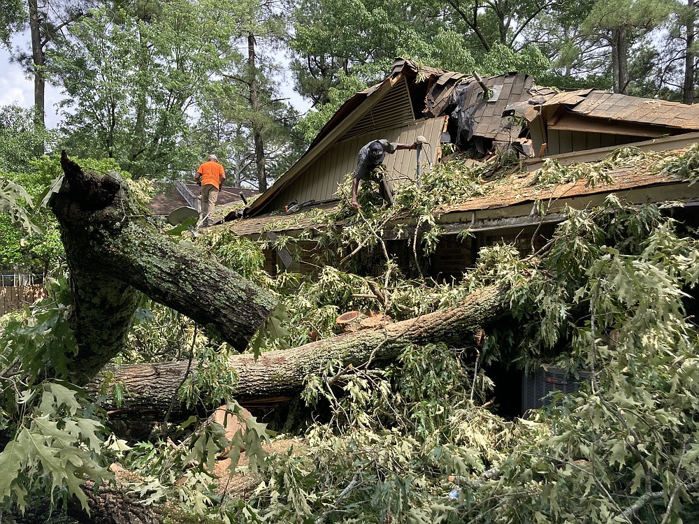 A second tree fell on this Cherry Street home on Tuesday, a day after a first large oak crushed the other end of the house. (Pine Bluff Commercial/Byron Tate)