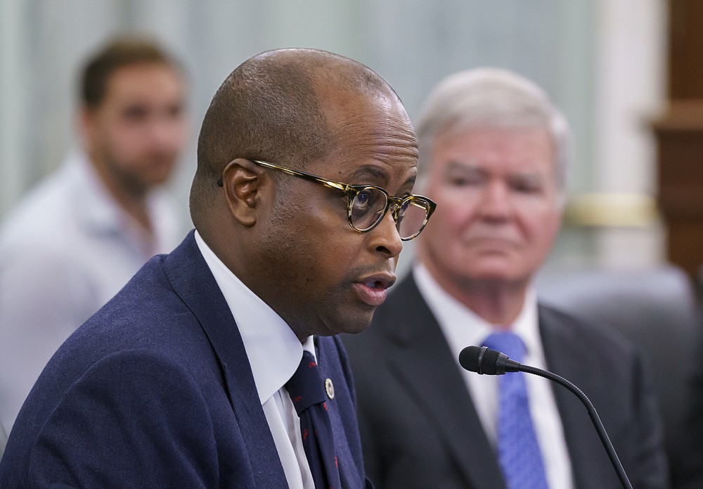 Howard University President Wayne A. I. Frederick, left, joined by NCAA President Mark Emmert, right, speaks as the Senate Commerce, Science, and Transportation Committee holds a hearing on student athlete compensation and federal legislative proposals to enable athletes participating in collegiate sports to monetize their name, image, and likeness, at the Capitol in Washington, Wednesday, June 9, 2021. (AP Photo/J. Scott Applewhite)