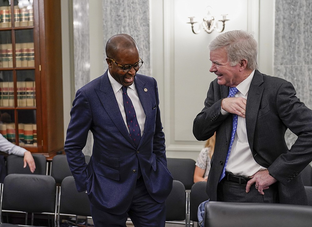 Howard University President Wayne A. I. Frederick, left, speaks with NCAA President Mark Emmert as the Senate Commerce, Science, and Transportation Committee prepares to hold a hearing on student athlete compensation and federal legislative proposals to enable athletes participating in collegiate sports to monetize their name, image, and likeness, at the Capitol in Washington, Wednesday, June 9, 2021. (AP Photo/J. Scott Applewhite)
