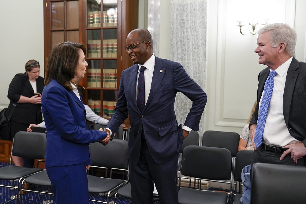 Sen. Maria Cantwell, D-Wash., chair of the Senate Commerce, Science, and Transportation Committee, left, greets Howard University President Wayne A. I. Frederick, center, and NCAA President Mark Emmert, as her panel holds a hearing on student athlete compensation and federal legislative proposals to enable athletes participating in collegiate sports to monetize their name, image, and likeness, at the Capitol in Washington, Wednesday, June 9, 2021. (AP Photo/J. Scott Applewhite)