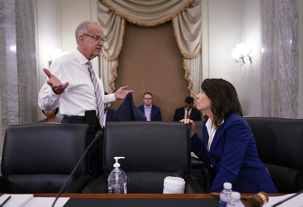 Sen. Jerry Moran, R-Kan., left, speaks with Sen. Maria Cantwell, D-Wash., chair of the Senate Commerce, Science, and Transportation Committee, as the panel holds a hearing on student athlete compensation and federal legislative proposals to enable athletes participating in collegiate sports to monetize their name, image, and likeness, at the Capitol in Washington, Wednesday, June 9, 2021. (AP Photo/J. Scott Applewhite)