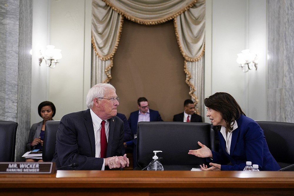 Sen. Roger Wicker, R-Miss., left, and Sen. Maria Cantwell, D-Wash., chair of the Senate Commerce, Science, and Transportation Committee, prepare to hold a hearing on student athlete compensation and federal legislative proposals to enable athletes participating in collegiate sports to monetize their name, image, and likeness, at the Capitol in Washington, Wednesday, June 9, 2021. (AP Photo/J. Scott Applewhite)