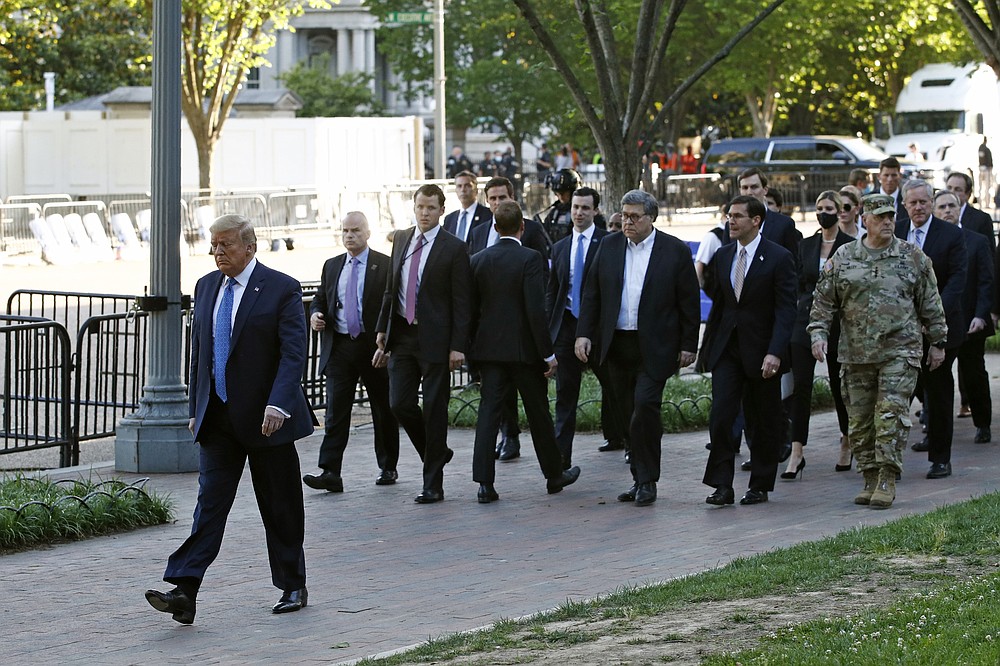 FILE - In this June 1, 2020 file photo, President Donald Trump walks in Lafayette Park to visit outside St. John's Church across from the White House in Washington. An internal investigation has determined that the decision to clear racial justice protestors from an area in front of the White House last summer was not influenced by then-President Donald Trump’s plans for a photo opportunity at that spot. The report released Wednesday by the Department of Interior’s Inspector General concludes that the protestors were cleared by U.S. Park Police on June 1 of last year so new fencing could be installed. (AP Photo/Patrick Semansky)
