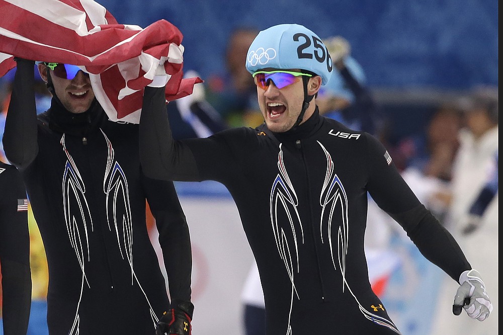 FILE - Eddy Alvarez celebrates with teammates after placing second in the 5000 meter short track speedskating relay final during the 2014 Winter Olympics in Sochi, Russia, in this Feb. 21, 2014, file photo. Alvarez helped the U.S. reach the Olympic baseball tournament and could become only the third American to win medals at the summer and winter Games. (AP Photo/Darron Cummings, File)