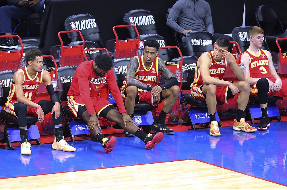Atlanta Hawks' Trae Young, Solomon Hill, John Collins, Bogan Bogdanovic and Kevin Huerter, from left, sit on the bench in the final minute of the team's 118-102 loss to the Philadelphia 76ers in Game 2 of an NBA basketball Eastern Conference semifinal series Tuesday, June 8, 2021, in Philadelphia. (Curtis Compton/Atlanta Journal-Constitution via AP)