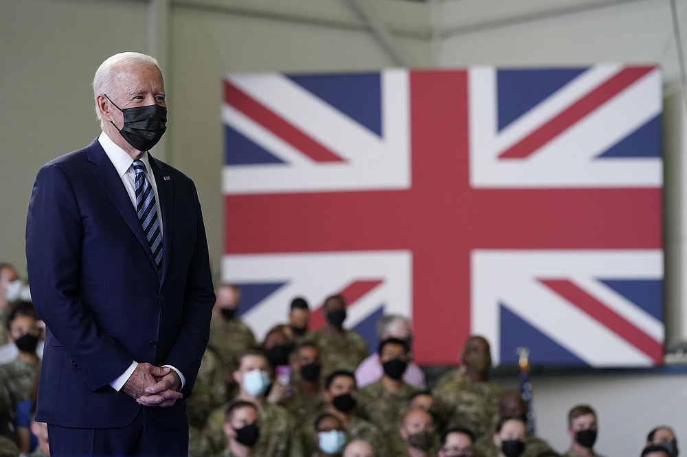 President Joe Biden listens as first lady Jill Biden speaks to American service members at RAF Mildenhall in Suffolk, England, Wednesday, June 9, 2021. (AP Photo/Patrick Semansky)