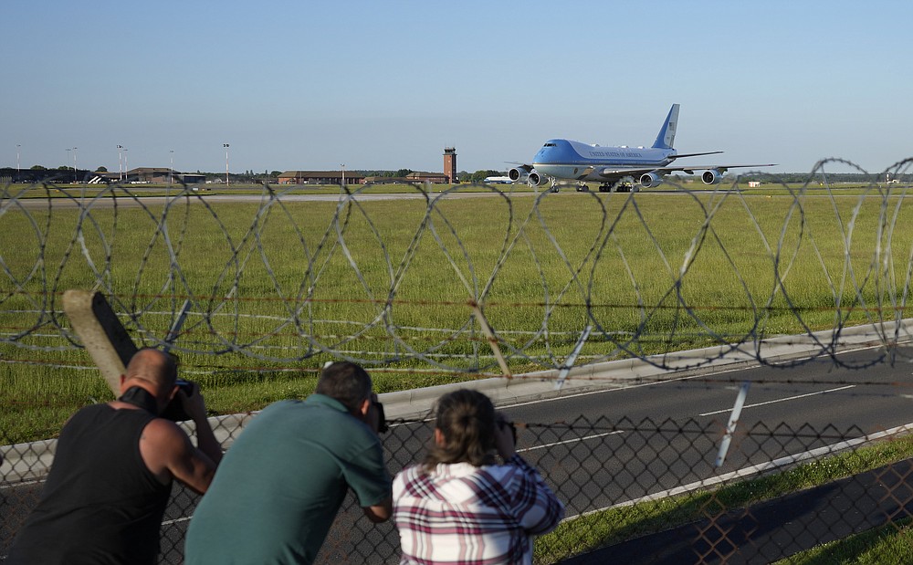 People take photos as Air Force One, carrying U.S. President Joe Biden and first lady Jill Biden arrives at RAF Mildenhall, near Bury St Edmunds, in eastern England, Wednesday, June 9, 2021. Biden will attend the G7 summit in Cornwall in southwest England. (AP Photo/Matt Dunham)