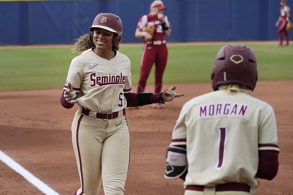Florida State's Elizabeth Mason (5) gestures as she heads home to score during the first inning of the second game of the NCAA Women's College World Series softball championship series against Oklahoma, Wednesday, June 9, 2021, in Oklahoma City. (AP Photo/Sue Ogrocki)