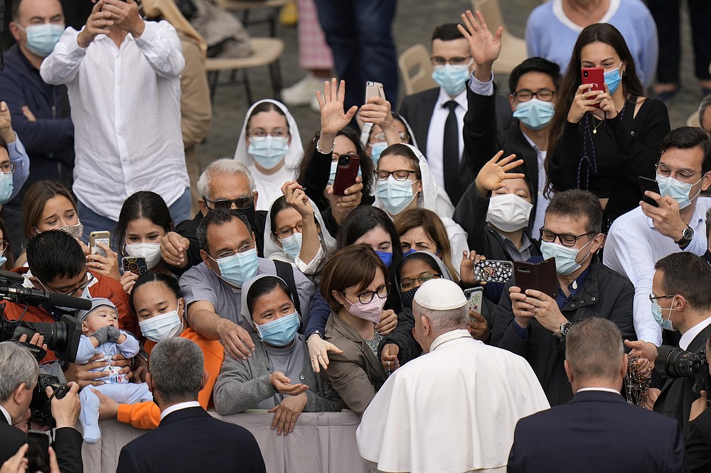 Pope Francis is greeted by faithful as he arrives for his weekly general audience, at the Vatican, Wednesday, June 9, 2021. (AP Photo/Alessandra Tarantino)