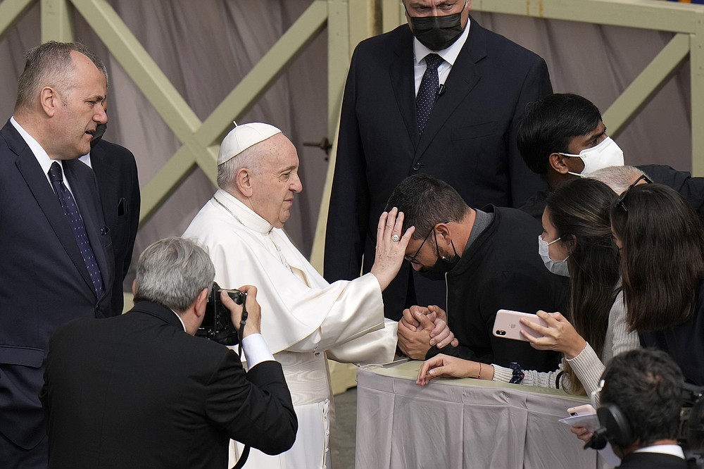 Pope Francis blesses and attendee as he arrives for his weekly general audience, at the Vatican, Wednesday, June 9, 2021. (AP Photo/Alessandra Tarantino)