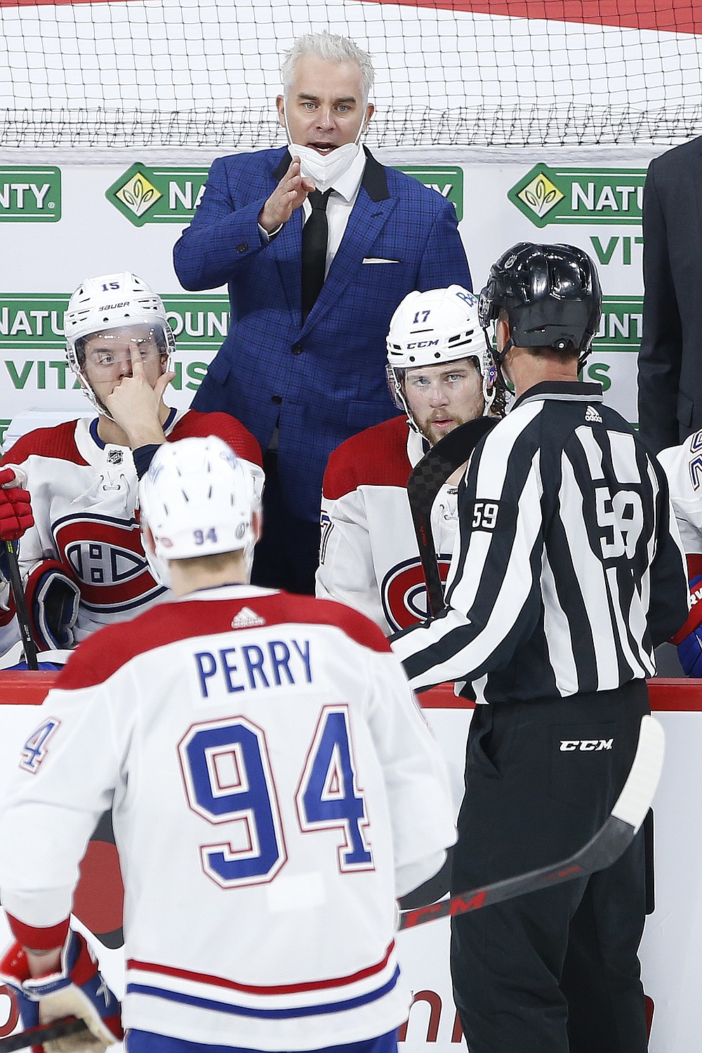 Montreal Canadiens coach Dominique Ducharme talks to a linesman during the third period of Game 2 of an NHL hockey Stanley Cup second-round playoff series against the Winnipeg Jets on Friday, June 4, 2021, in Winnipeg, Manitoba. (John Woods/The Canadian Press via AP)