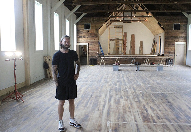 Tom Black of Natural State Renovations is seen inside the gymnasium of the historic schoolhouse on Old School Way in Rudy. Once renovated, the gym will hold wedding receptions and concerts as part of the Old School Venue.
