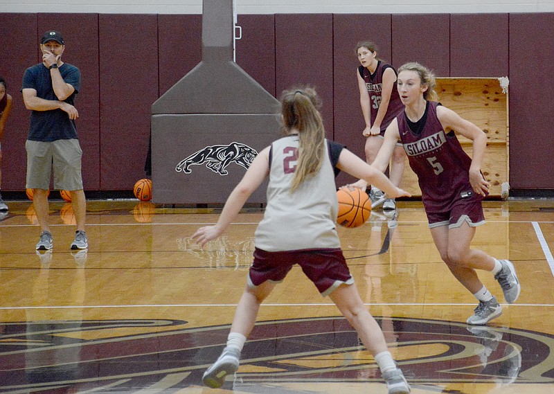 Graham Thomas/Siloam Sunday
Siloam Springs guard Cailee Johnson brings the ball up the floor as Addison Pilcher guards during girls basketball practice on Wednesday morning at Siloam Springs HIgh School. The Lady Panthers participated at a team camp at Rogers High on Thursday and Friday and will be heading to another team camp at Oral Roberts on Monday, Tuesday and Wednesday of this week.