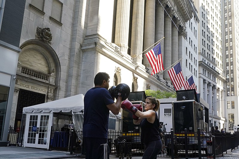 A woman and her trainer workout outside the New York Stock Exchange, Monday, June 7, 2021. Stocks are opening higher on Wall Street Thursday, June 10 nudging the S&P 500 back into the green for the week. The benchmark index was up 0.6% in the early going, and the tech-heavy Nasdaq was up 0.4%. (AP Photo/Richard Drew)