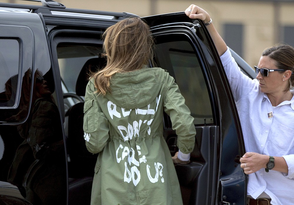 FILE - In this June 21, 2018 file photo, first lady Melania Trump arrives at Andrews Air Force Base, Md. wearing a Zara jacket that reads, "I don't really care. Do U?" after visiting the Upbring New Hope Children Center run by the Lutheran Social Services of the South in McAllen, Texas. (AP Photo/Andrew Harnik, File)