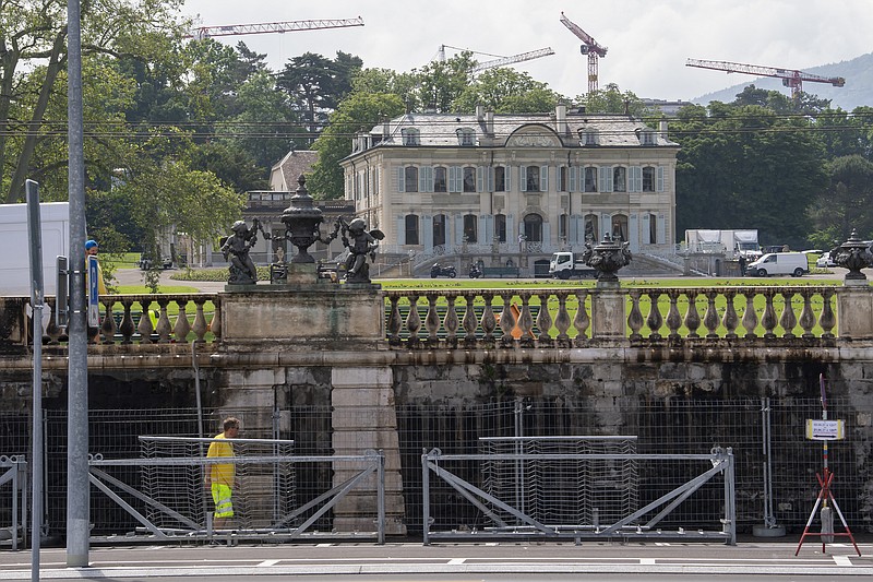 Fences are set up in front of the "Villa La Grange" in the Parc La Grange at the Eaux-Vives in Geneva, Switzerland, Wednesday, June 09, 2021. The "Villa La Grange" is the possible but yet unconfirmed venue of the meeting between US president Joe Biden and Russian presidents Vladimir Putin in Geneva, scheduled on Wednesday June 16, 2021.  (Martial Trezzini/Keystone via AP)