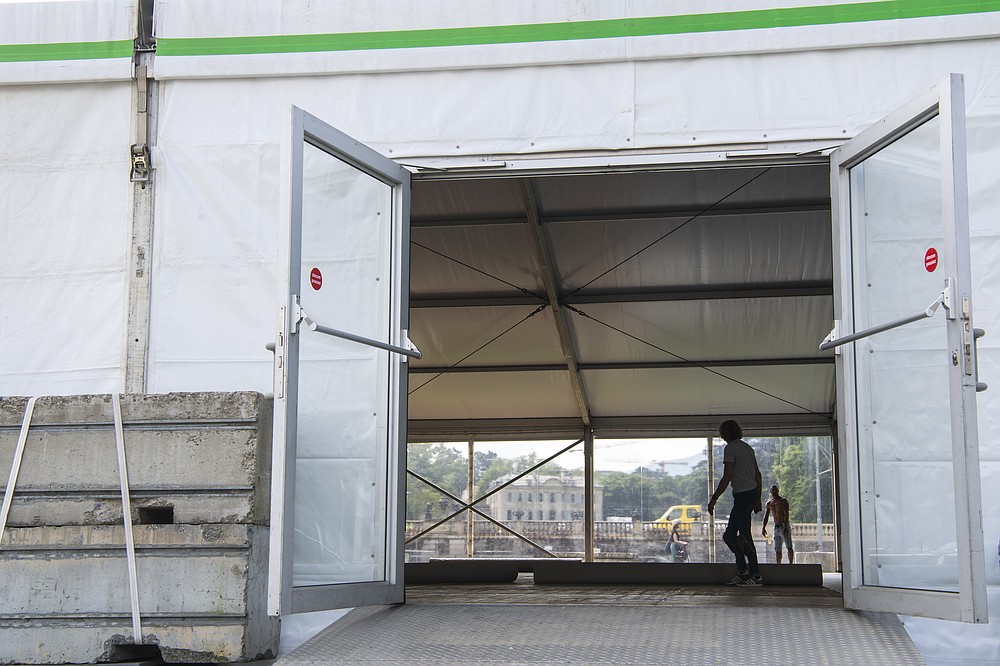 Workers are working to set up a giant tent outside Parc La Grange aux Eaux-Vives in Geneva, Switzerland, Wednesday, June 09, 2021. The "Villa La Grange" is the possible but yet unconfirmed venue of the meeting between US president Joe Biden and Russian presidents Vladimir Putin in Geneva, scheduled on Wednesday June 16, 2021. (Martial Trezzini/Keystone via AP)