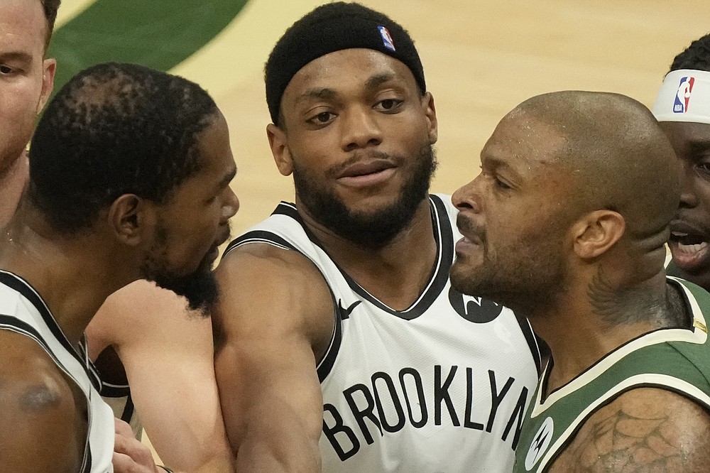 Brooklyn Nets' Bruce Brown tries to break up Kevin Durant and Milwaukee Bucks' Bryn Forbes during the second half of Game 3 of the NBA Eastern Conference basketball semifinals game Thursday, June 10, 2021, in Milwaukee. (AP Photo/Morry Gash)