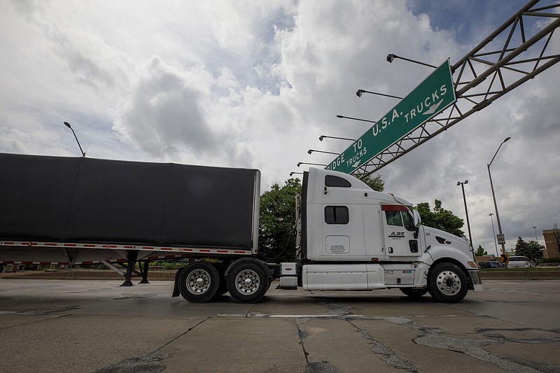 A truck enters a queue to cross the Ambassador Bridge into Detroit, Michigan, from Windsor, Ontario, on May 26, 2021. MUST CREDIT: Bloomberg photo by Cole Burston.