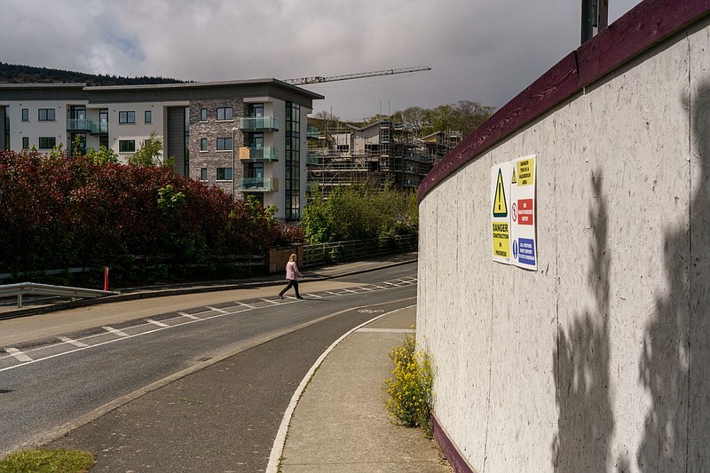 A pedestrian walks near a residential construction site in south Dublin, Ireland, on May 10, 2021. MUST CREDIT: Bloomberg photo by Paulo Nunes dos Santos.
