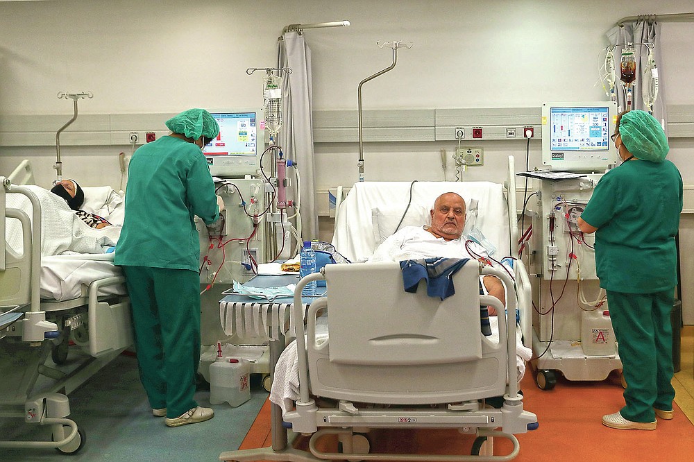 Nurses check patients undergoes dialysis at the Lebanese American University Medical Center-Rizk Hospital in Beirut, Lebanon, Thursday, June 10, 2021. Hospitals in Lebanon warned on Thursday that they may be forced to suspend kidney dialysis next week amid severe shortages in supplies needed, the latest manifestation of Lebanon's accelerating financial crisis and collapsing health sector. (AP Photo/Bilal Hussein)