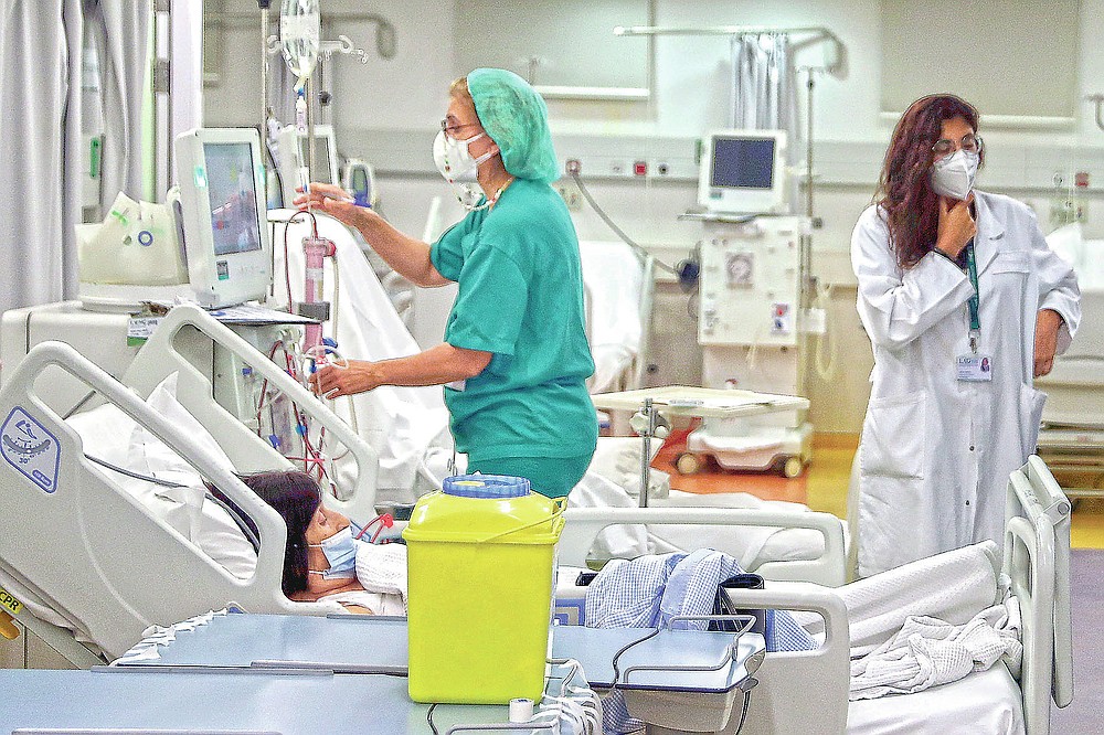 A nurse checks a patient undergoes dialysis at the Lebanese American University Medical Center-Rizk Hospital in Beirut, Lebanon, Thursday, June 10, 2021. Hospitals in Lebanon warned on Thursday that they may be forced to suspend kidney dialysis next week amid severe shortages in supplies needed, the latest manifestation of Lebanon's accelerating financial crisis and collapsing health sector. (AP Photo/Bilal Hussein)