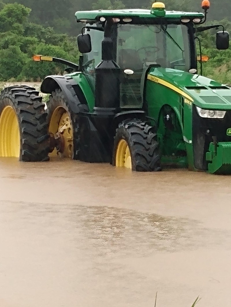 Water rises around a tractor Thursday in Chicot County. (Special to The Commercial, Clay Gibson/University of Arkansas System Division of Agriculture)