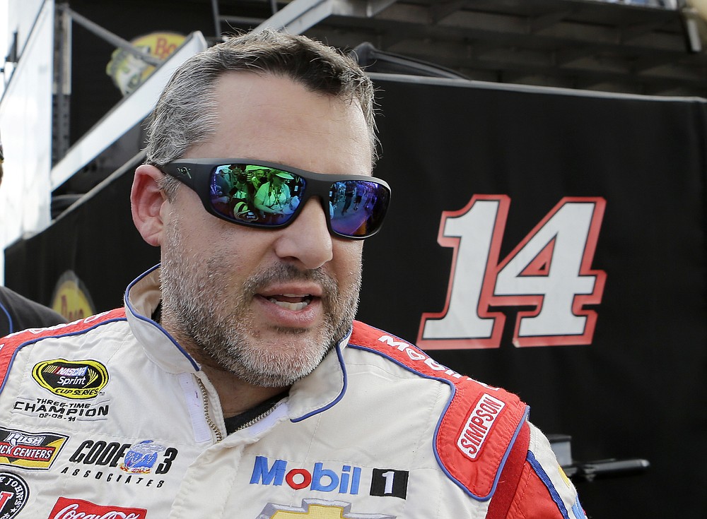 FILE - In this Nov. 19, 2016, file photo, Tony Stewart heads to the hauler after the NASCAR Sprint Cup Series Auto Racing practice in Homestead, Fla. Superstar Racing Experience was conceptualized as a series for former greats who still had the skills and desire to compete to square off in identically prepared cars at six of America’s classic short tracks. Ray Evernham and Tony Stewart took great care in extending invites to the made-for-TV league they had co-created and pulled in a dozen of the most iconic names in modern day motorsports. (AP Photo/Alan Diaz, File)
