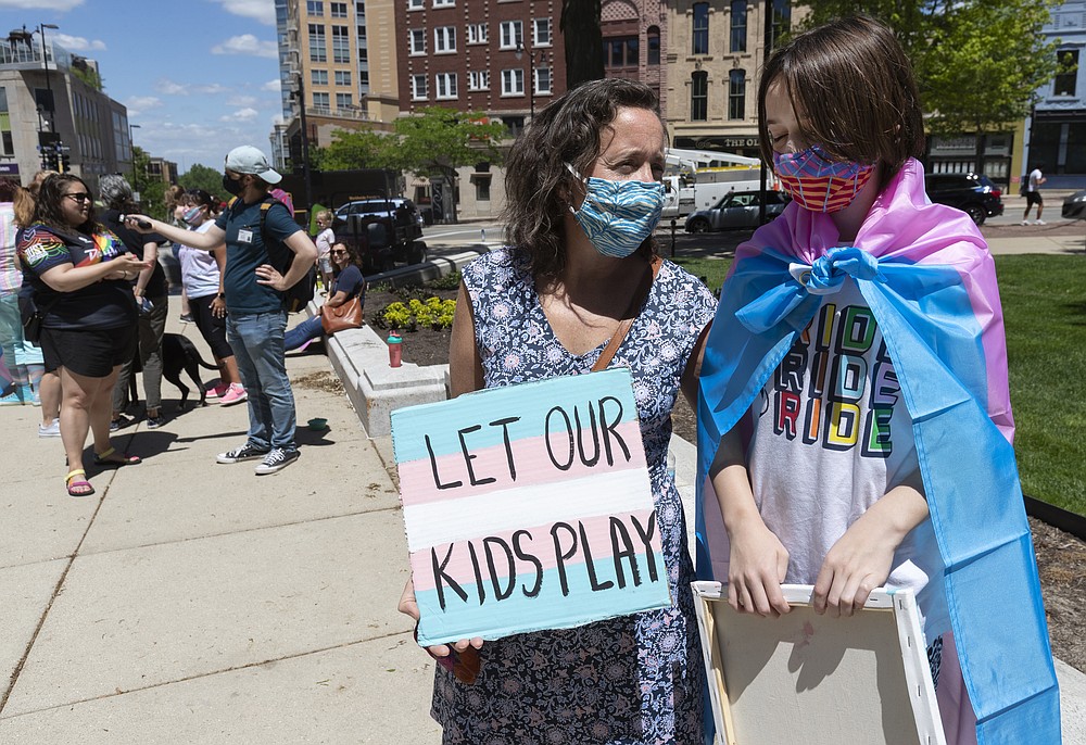 FILE - In this Wednesday, May 26, 2021 file photo, Maddy Niebauer and her 10-year-old transgender son, Julian, from Middleton, Wis., take part in a rally for transgender rights at the Capitol in Madison, Wis. Republicans who control the state Legislature are holding hearings Wednesday on legislation that would ban transgender athletes from competing in girls' and women's school sports — a proposal opposed by nearly 20 groups, including the statewide body that oversees high school sports. (Mark Hoffman/Milwaukee Journal-Sentinel via AP, File)=WIMIL