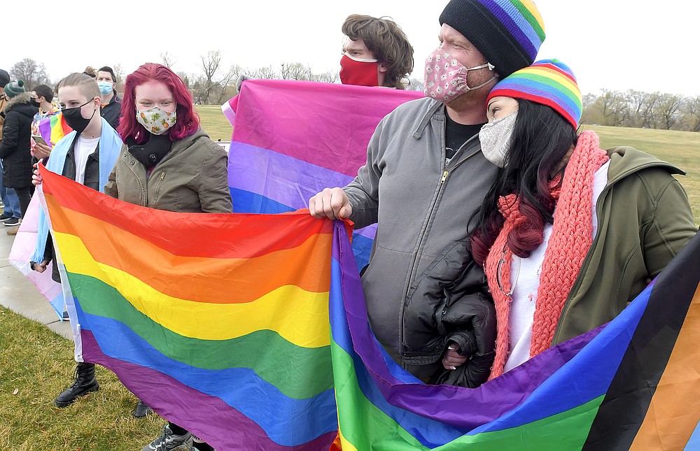 FILE - In this Wednesday, April 14, 2021 file photo, members of the Olsen and Thorell family hold pride flags during a rally in support of LGBTQ students at Ridgeline High School in Millville, Utah. Students and school district officials in Utah are outraged after a high school student ripped down a pride flag to the cheers of other students during diversity week. A rally was held the following day in response to show support for the LGBTQ community. (Eli Lucero/The Herald Journal via AP, File)/The Herald Journal via AP)