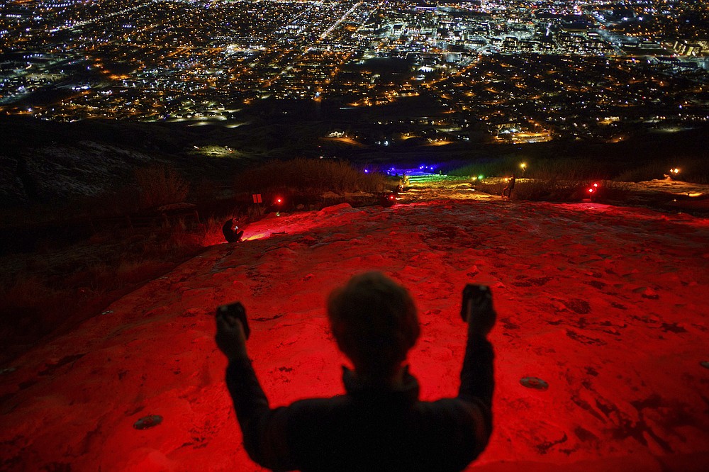 FILE - In this Thursday, March 4, 2021. file photo, a group of people, including many BYU students shine Pride colors on the Y on the mountain above BYU in Provo, Utah. Students at Brigham Young University illuminated the letter "Y" on a mountain overlooking the Provo campus on Thursday with rainbow colors in a display meant to send a message to the religious school. (Trent Nelson/The Salt Lake Tribune via AP, File)