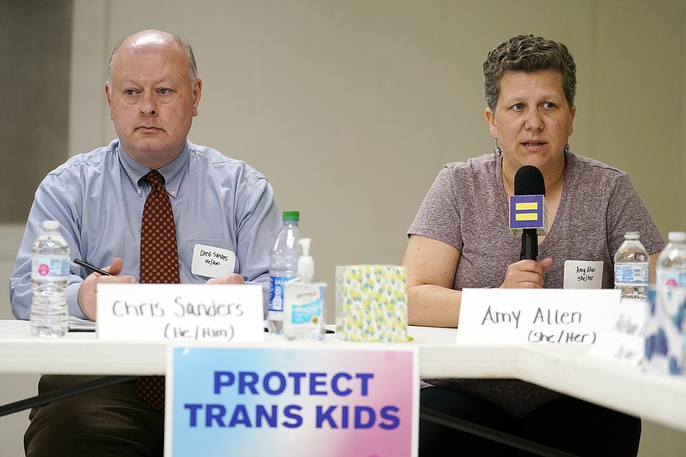 FILE - In this Friday, May 21, 2021 file photo, Amy Allen, the mother of an eighth grade transgender son, speaks at a Human Rights Campaign round table discussion on anti-transgender laws, in Nashville, Tenn. Allen says her family is dismayed by the multiple anti-trans bills winning approval in Tennessee – including one exposing public schools to lawsuits if they let transgender students use multi-person bathrooms or locker rooms that don't reflect their sex at birth. At left is Chris Sanders, Tennessee Equality Project executive director. (AP Photo/Mark Humphrey, File)