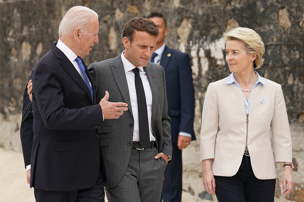 President Joe Biden talks to French President Emmanuel Macron and EU Commission President Ursula von der Leyen after he was invited to the G-7 family photo with guests at the G-7 summit on Friday 11 June 2021 in Carbis Bay, England, has posed. (Kevin Lamarque / Pool via AP)