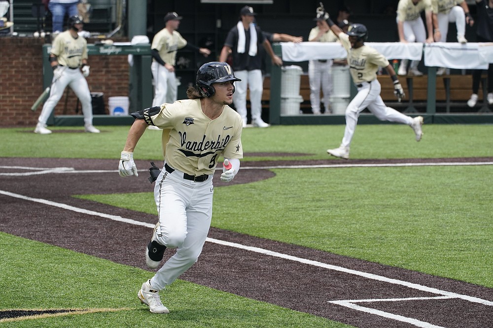 Vanderbilt's Carter Young (9) runs to first after hitting a single and driving in Javier Vaz, top right, against East Carolina during the fifth inning of an NCAA college baseball super regional game Saturday, June 12, 2021, in Nashville, Tenn. (AP Photo/Mark Humphrey)