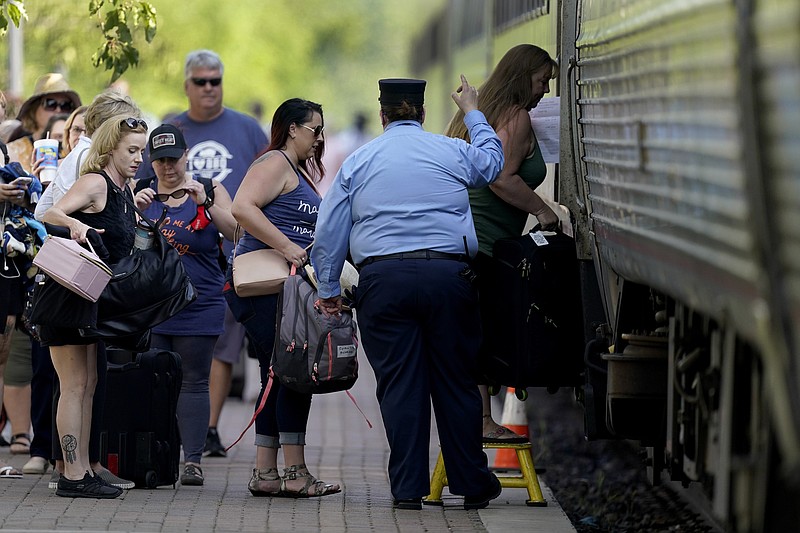 Passengers board a Missouri River Runner Amtrak train Friday, June 11, 2021, in Lee's Summit, Mo. Backers of a proposal to expand passenger rail service through Kansas, Oklahoma and Texas hope the long-discussed package finally has a chance because of an anticipated influx of federal infrastructure funding. (AP Photo/Charlie Riedel)