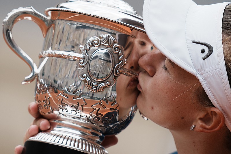 Czech Republic's Barbora Krejcikova kisses the trophy after defeating Russia's Anastasia Pavlyuchenkova during their final match of the French Open tennis tournament at the Roland Garros stadium Saturday, June 12, 2021 in Paris. The unseeded Czech player defeated Anastasia Pavlyuchenkova 6-1, 2-6, 6-4 in the final. (AP Photo/Thibault Camus)
