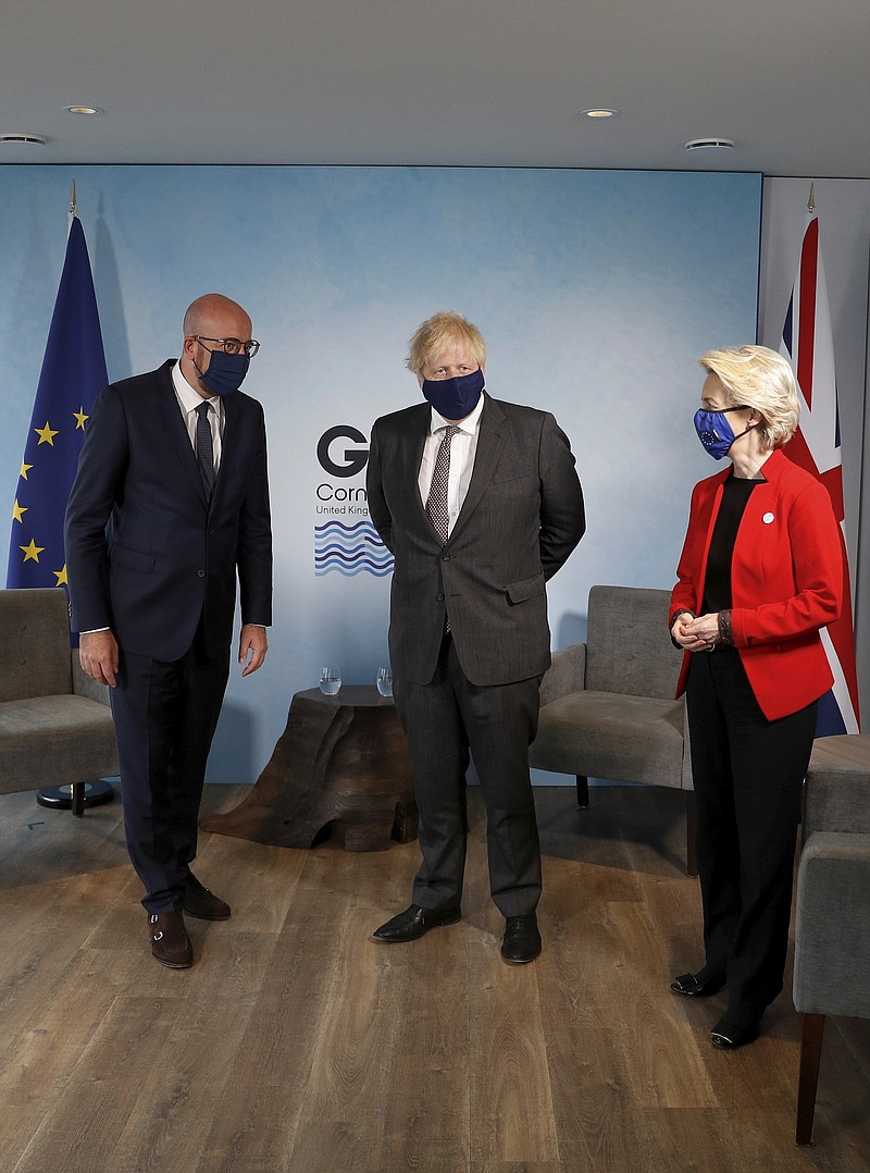 Britain's Prime Minister Boris Johnson, center, meets with European Commission President Ursula von der Leyen and European Council President Charles Michel, left, during the G7 summit in Cornwall, England, Saturday June 12, 2021. (Peter Nicholls/Pool via AP)